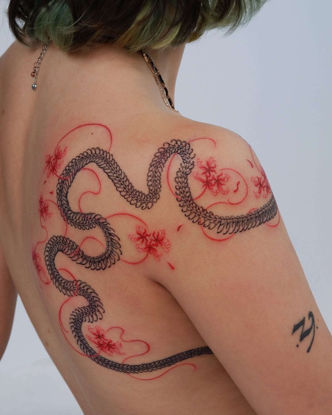 Intricate snake tattoo with floral elements