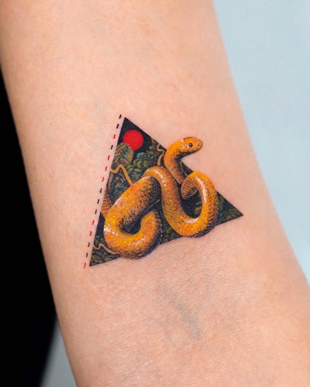 Vivid snake tattoo within triangular art