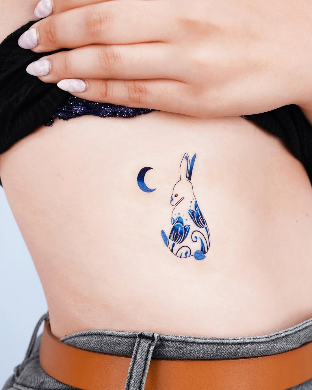 Charming Rib Tattoo Featuring a Bunny and Moon