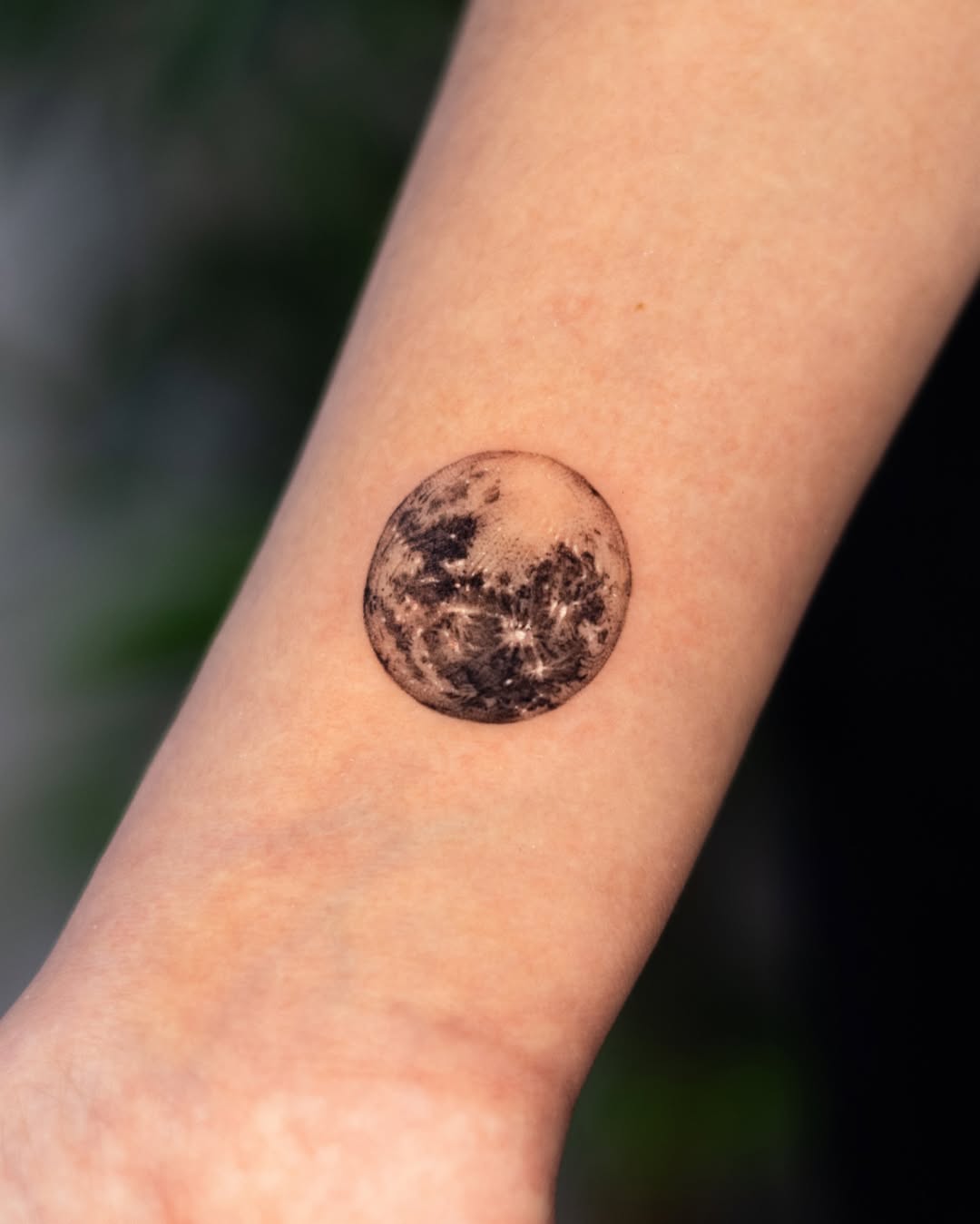 Intricate moon tattoo perfectly inked on skin
