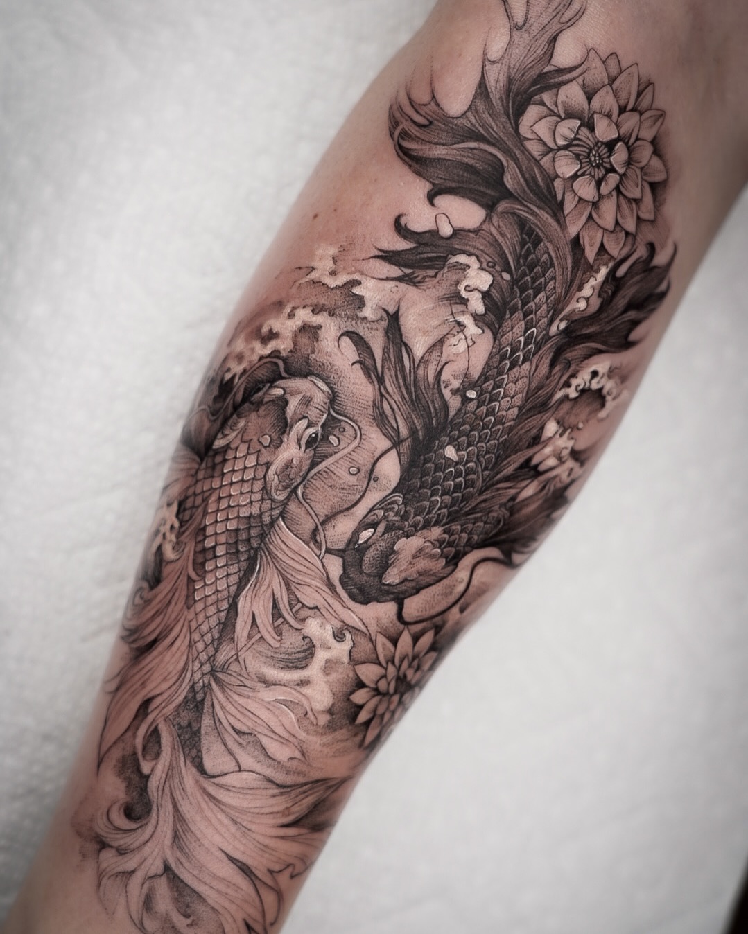 Intricate koi fish tattoo with flowing waves