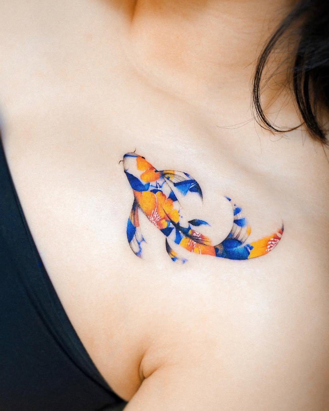Vibrant koi fish tattoo with floral elements