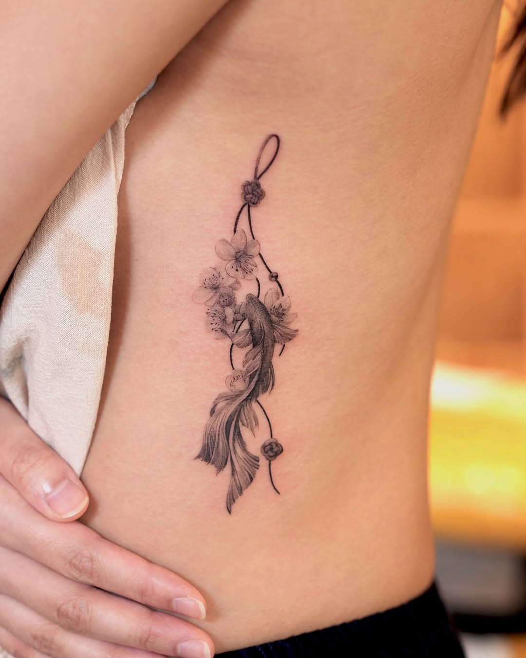 Elegant koi fish tattoo with floral accents