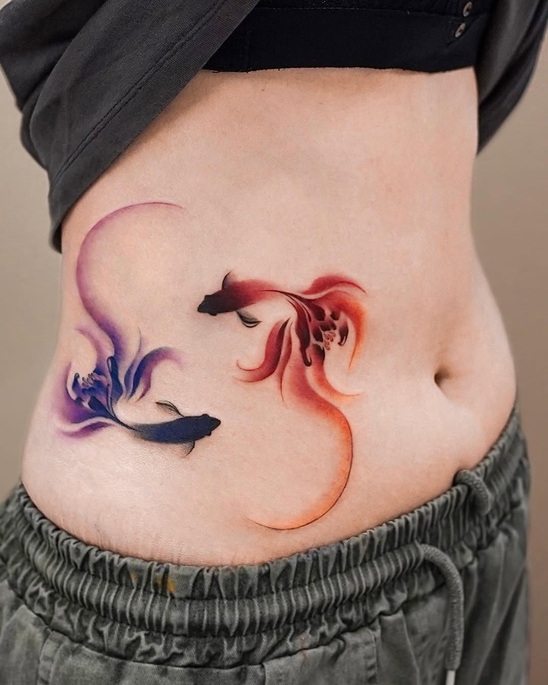 Artistic koi fish tattoo design on the belly