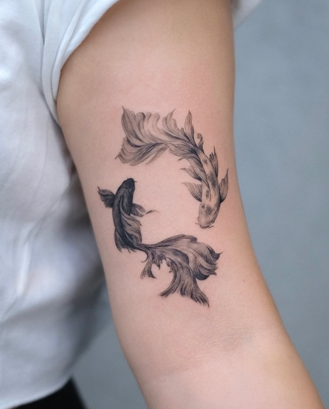 Elegant koi tattoo in black and gray tones