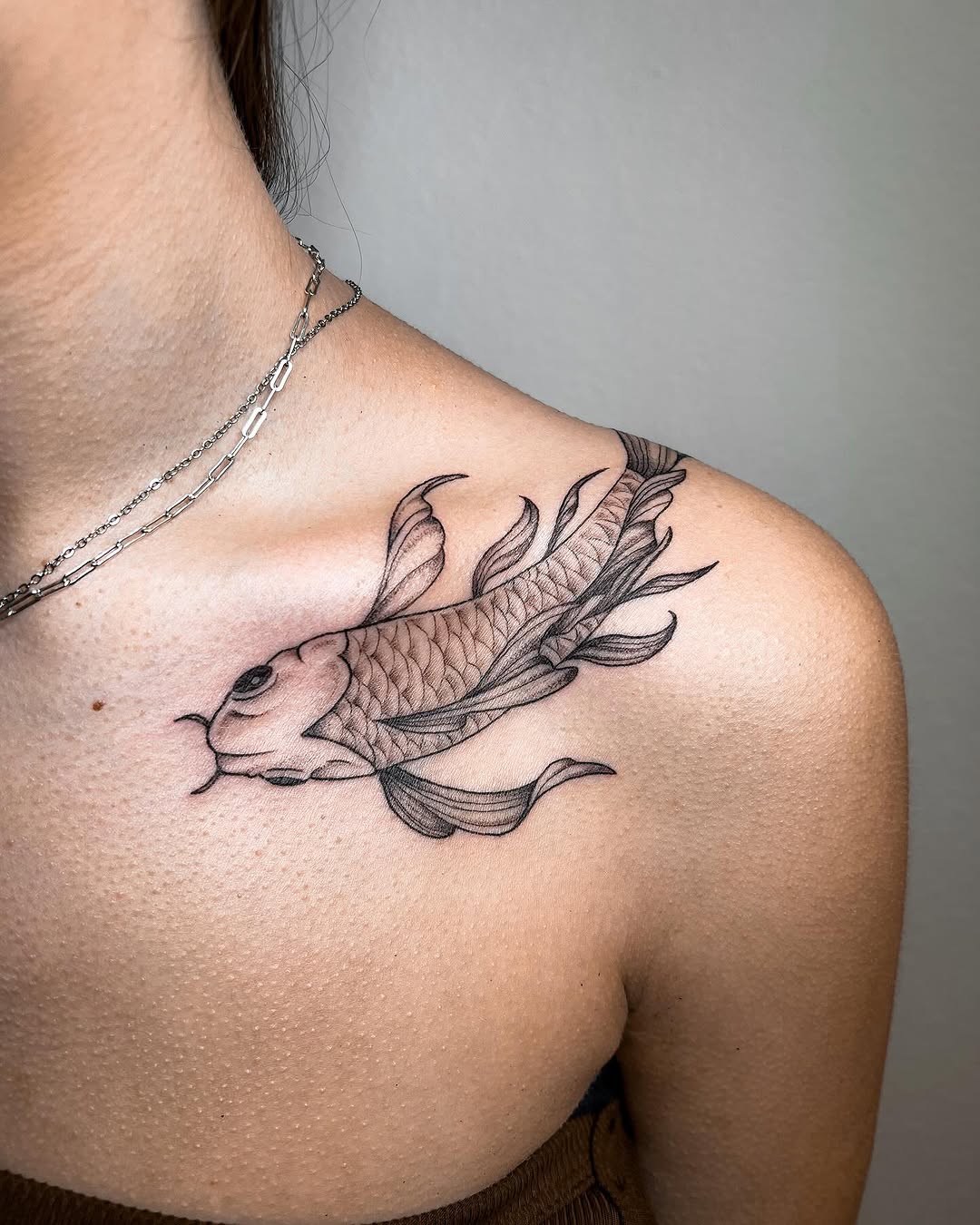 Elegant koi fish tattoo on shoulder.