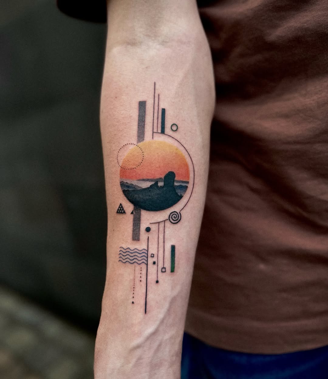 Captivating sunset landscape tattoo with geometric elements