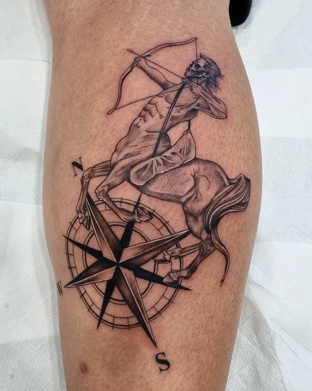 Bold Sagittarius Tattoo with Compass Design