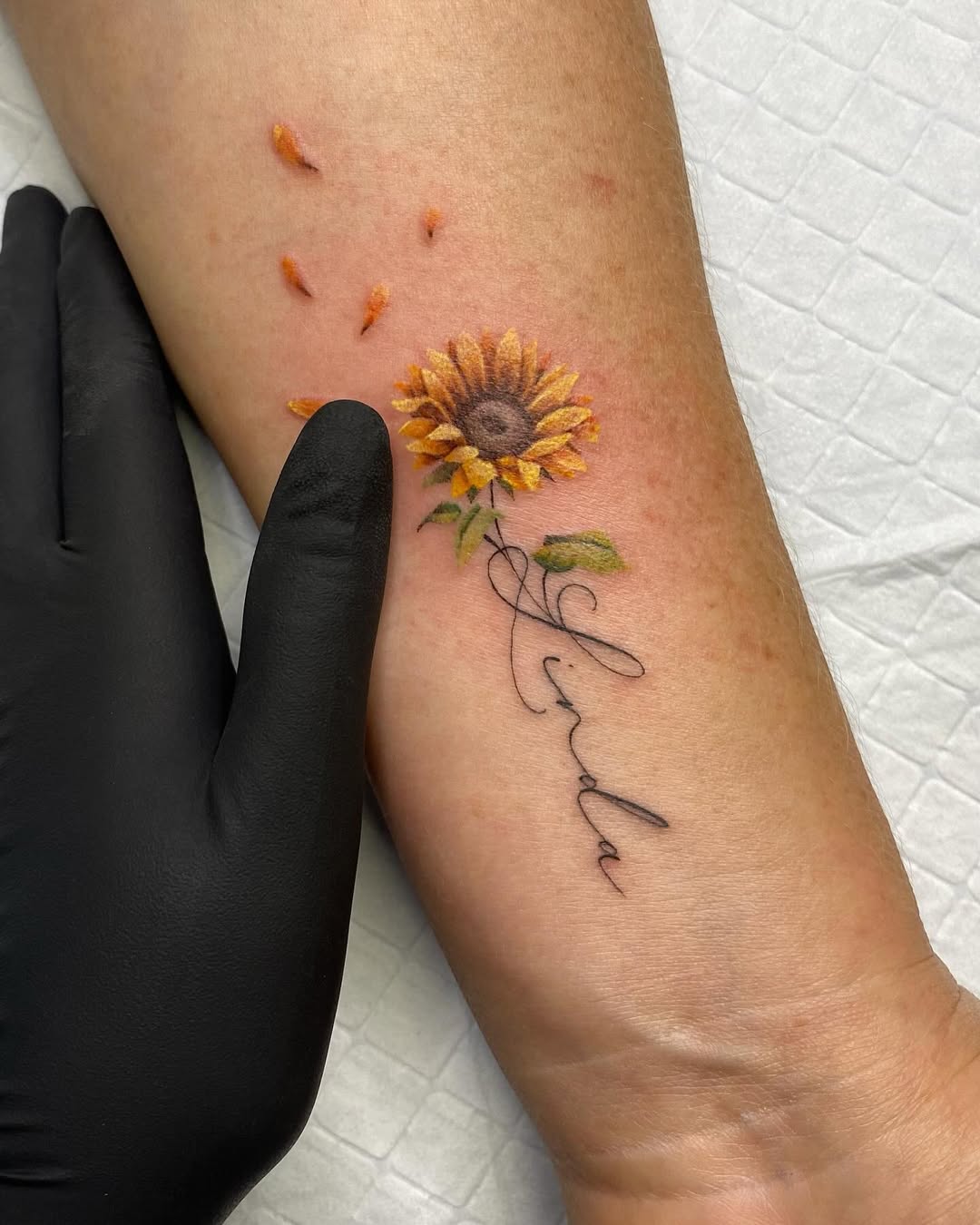 Stunning sunflower tattoo with personal touch