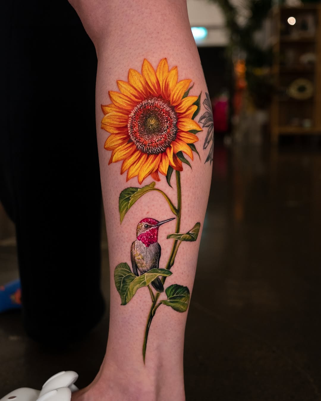 Vibrant sunflower with a hummingbird tattoo