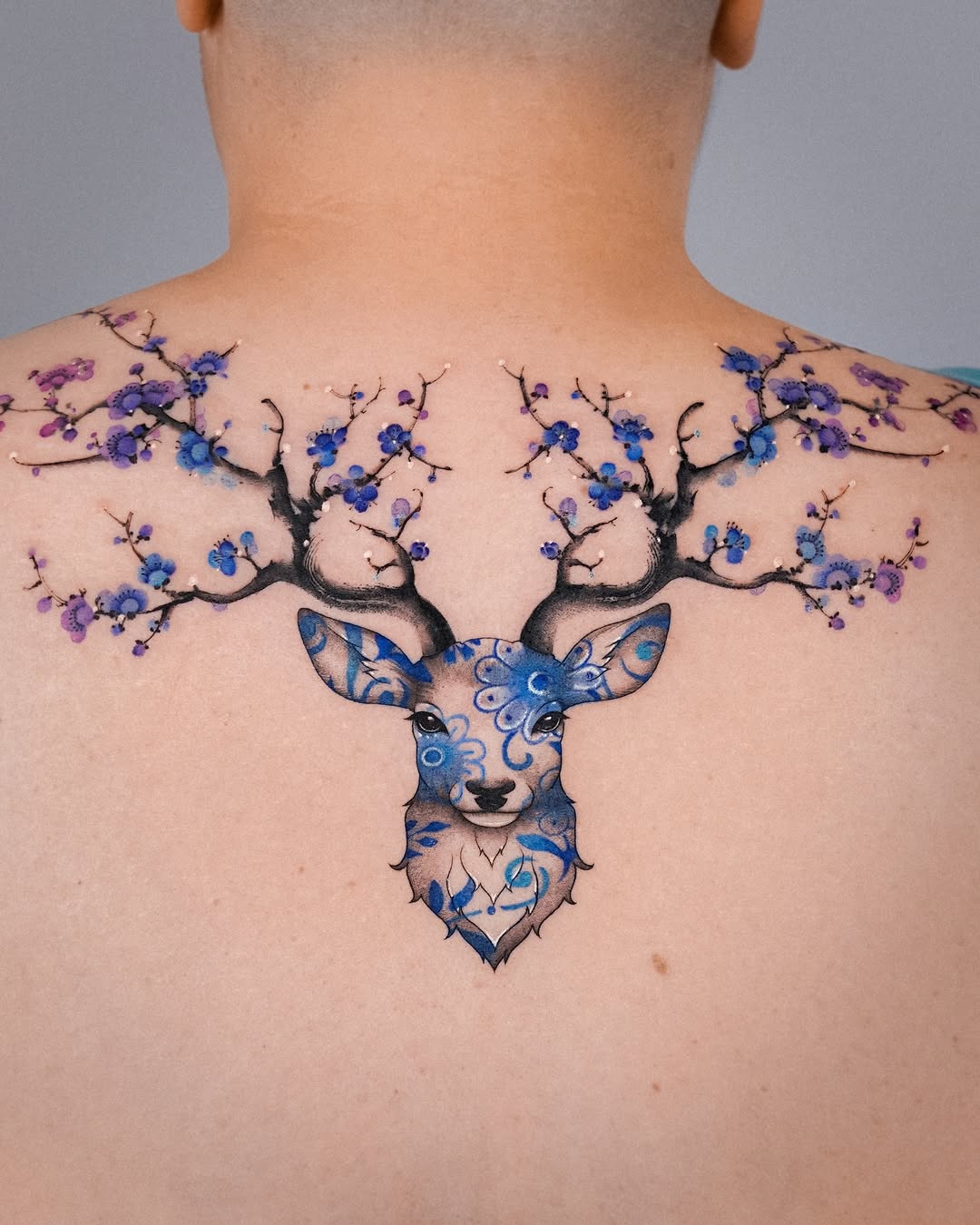 Floral deer tattoo with vibrant colors and details