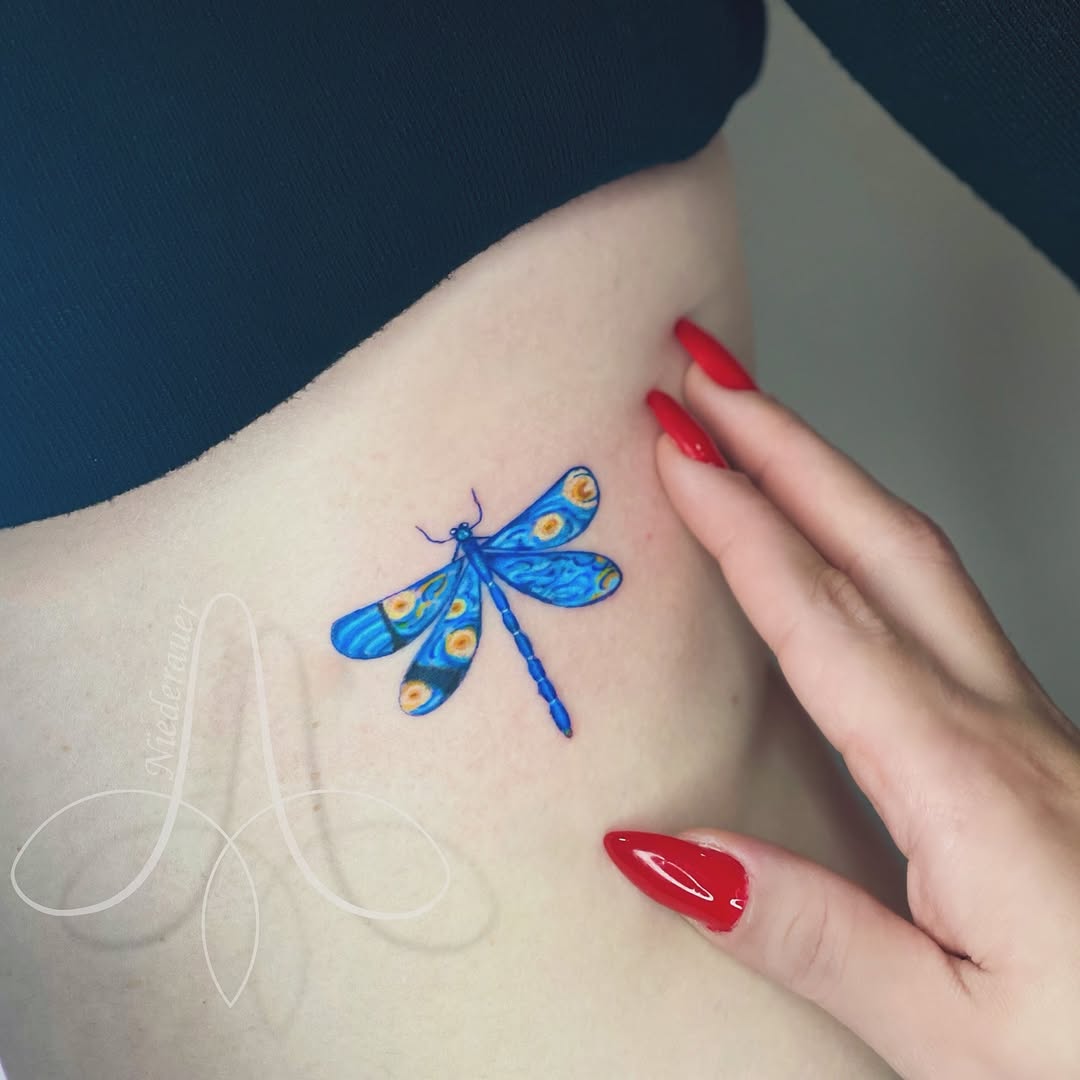 A vibrant dragonfly tattoo inspired by Van Gogh