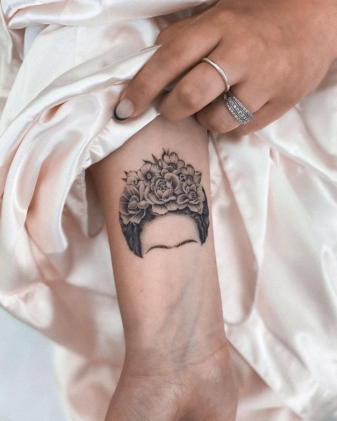 Elegant floral crown tattoo inspired by Frida