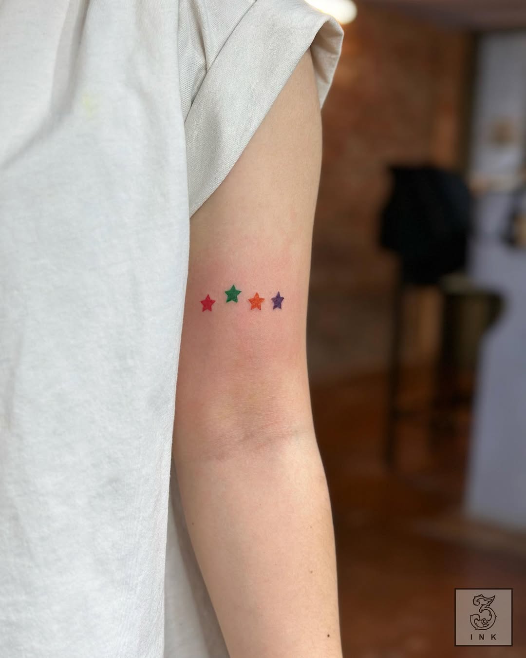 Colorful star tattoos in a unique arrangement