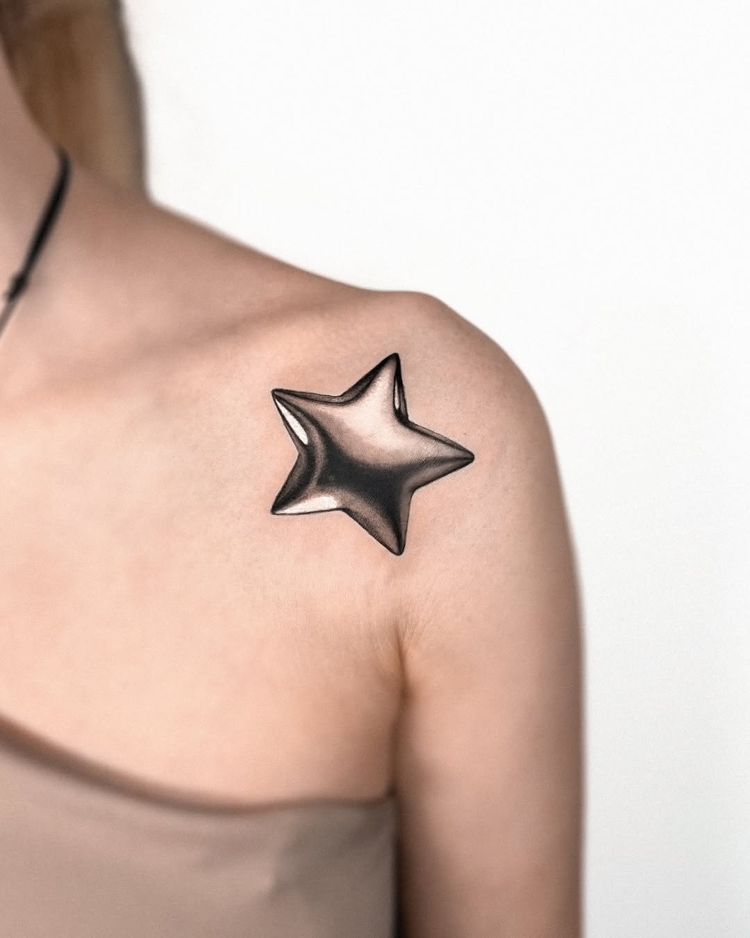 Stylish star tattoo with a shiny finish.